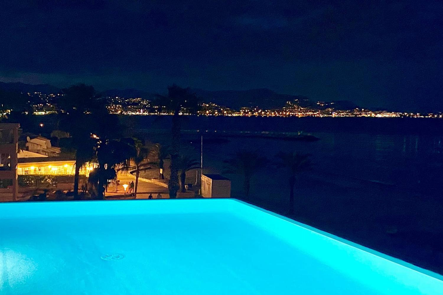 Shared pool with sea view at night