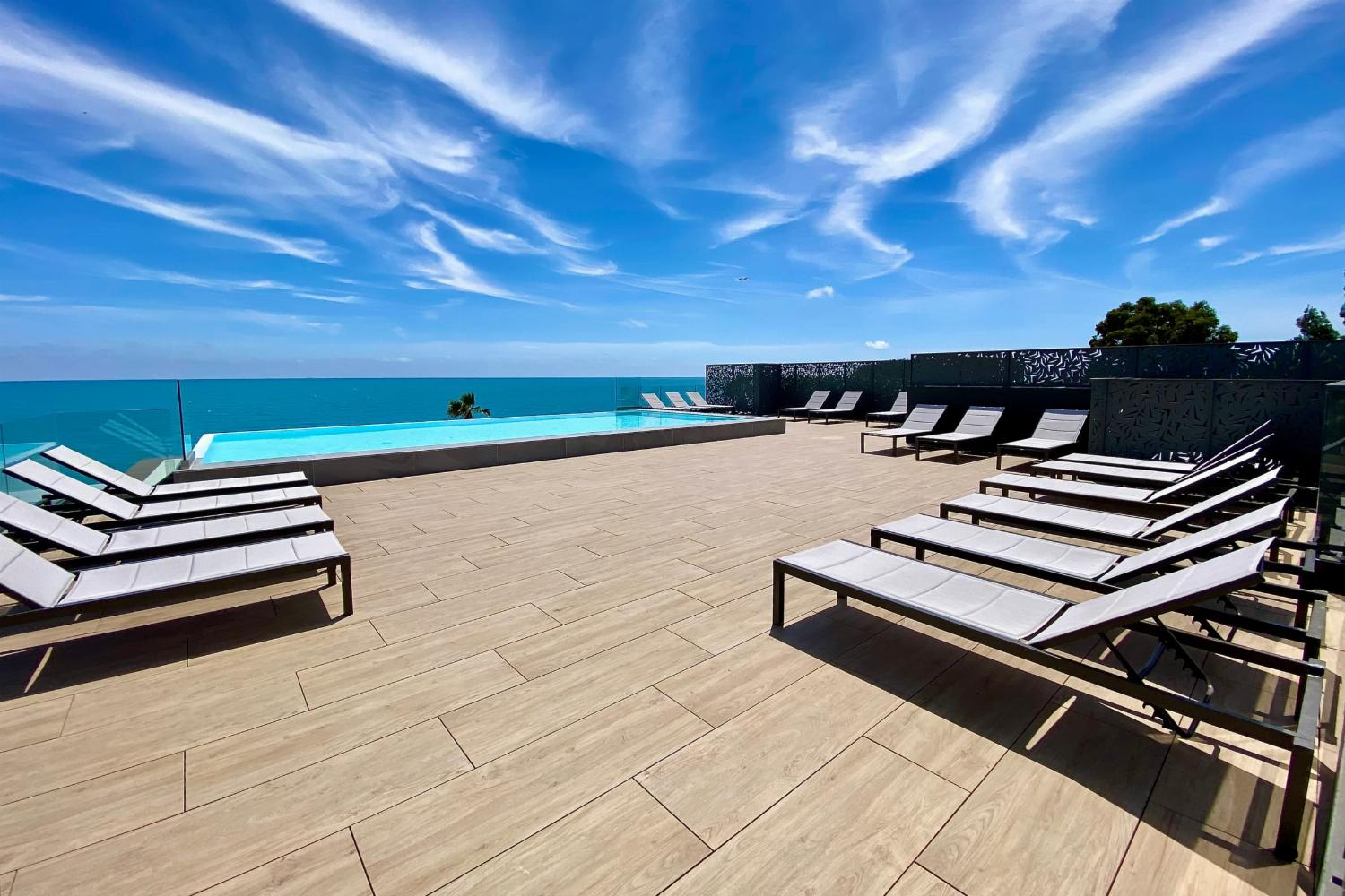 Shared pool with terrace and sea view