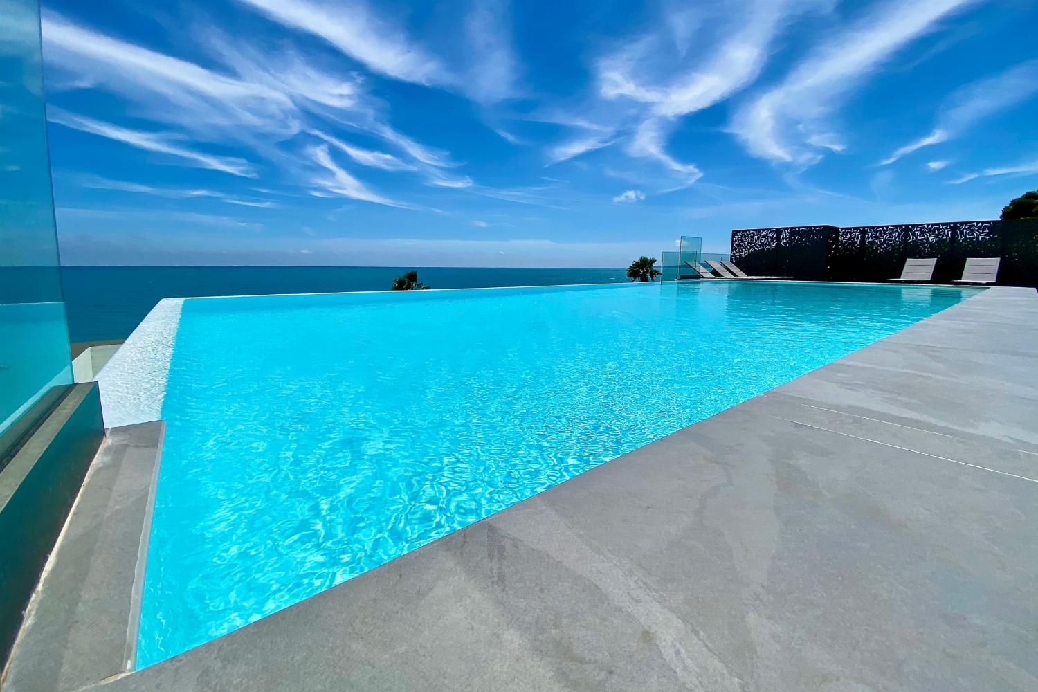 Shared pool with terrace and sea view