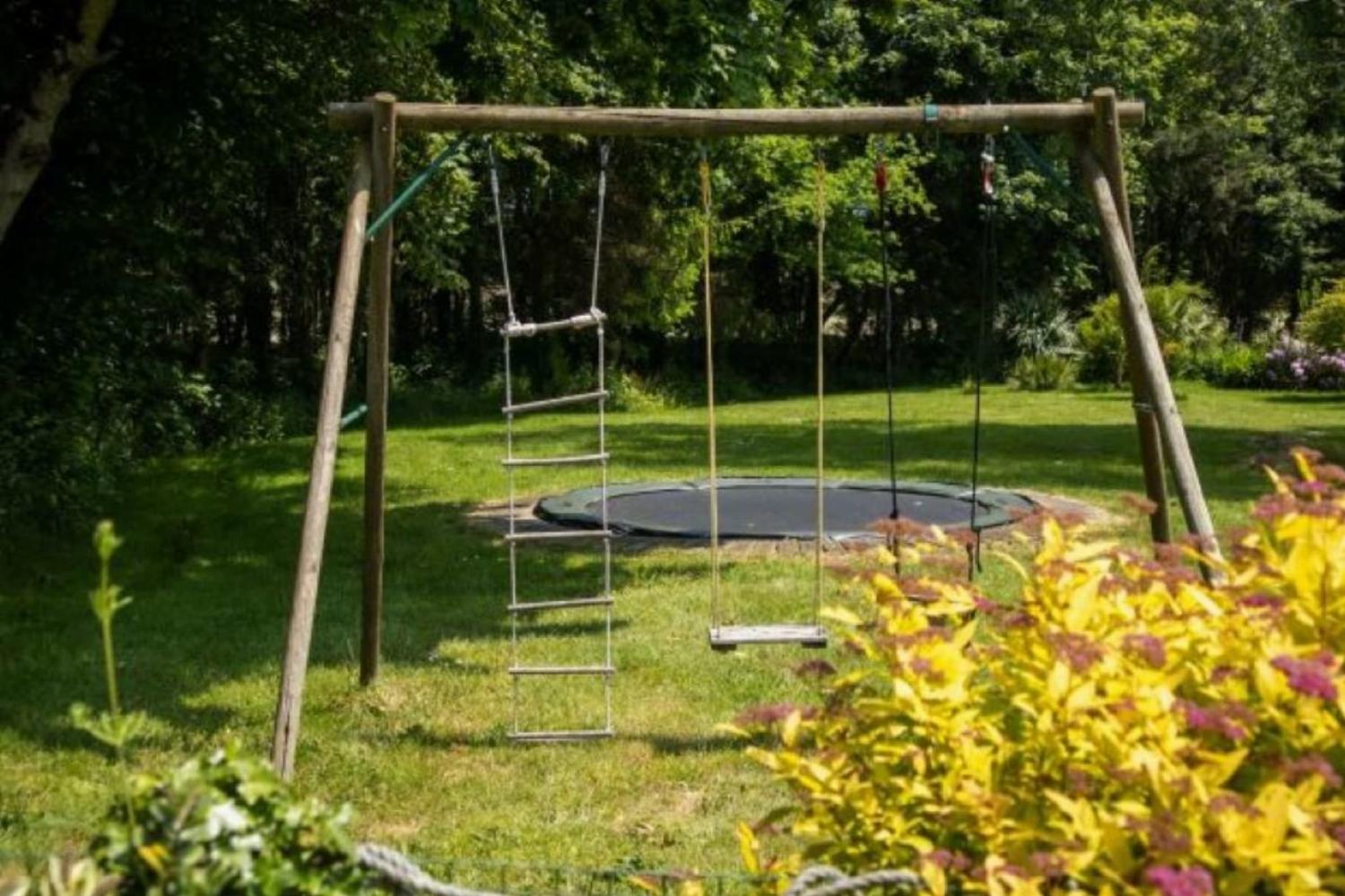 Swings and trampoline in garden